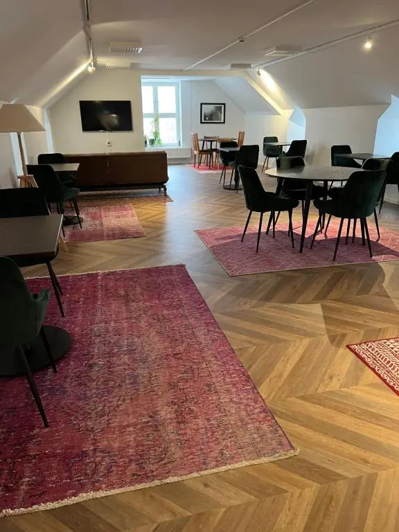 Shared lounge at Mini-Hotel Borås with seating areas and dining tables